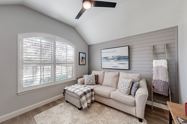 living room featuring ceiling fan, lofted ceiling, and a wealth of natural light