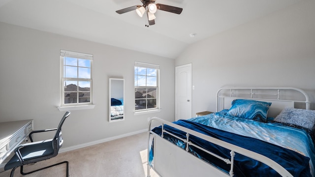 carpeted bedroom with ceiling fan and vaulted ceiling