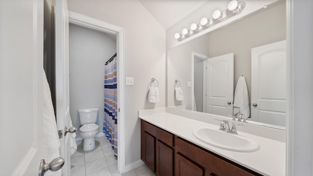 bathroom with tile patterned flooring, vanity, toilet, and vaulted ceiling