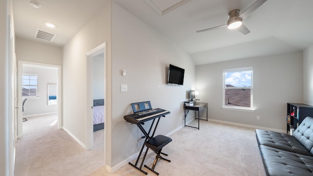 living room with a wealth of natural light, light carpet, and ceiling fan