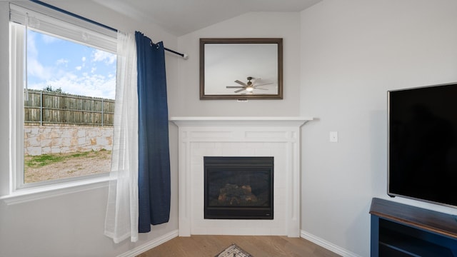 unfurnished living room featuring hardwood / wood-style floors, vaulted ceiling, and ceiling fan