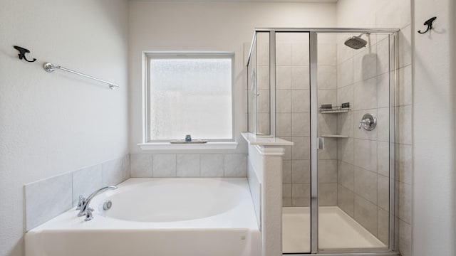 bathroom featuring independent shower and bath