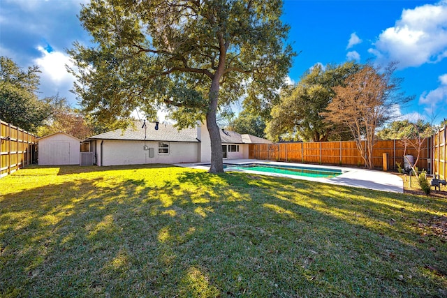 view of yard featuring a fenced in pool, a storage unit, and a patio area