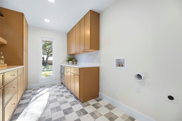 washroom with cabinets, hookup for a washing machine, and electric dryer hookup