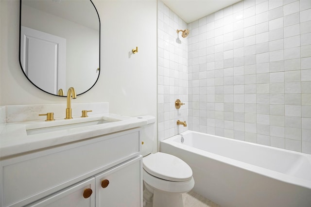 full bathroom featuring toilet, vanity, and tiled shower / bath