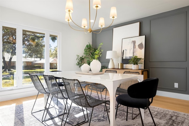 dining room featuring a wealth of natural light, a notable chandelier, and light hardwood / wood-style flooring