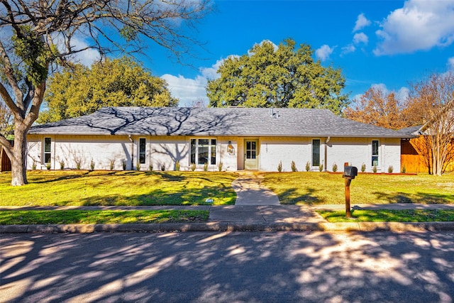 ranch-style home with a front yard