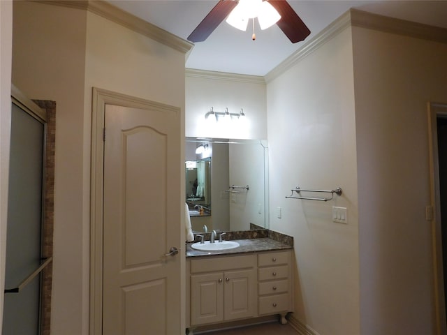 bathroom featuring ceiling fan, a shower with door, vanity, and ornamental molding