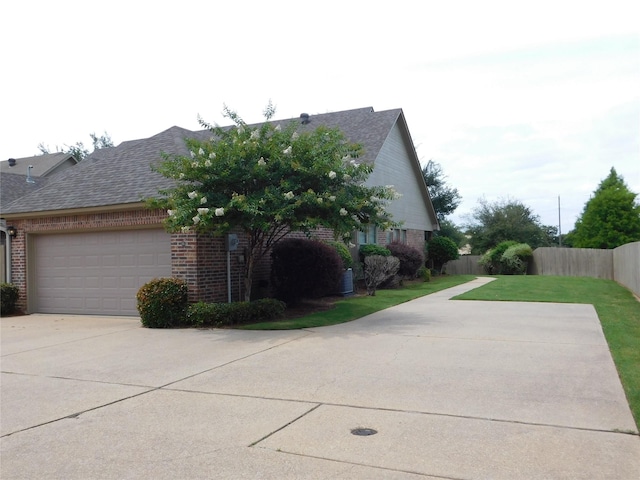 view of property exterior with a lawn and a garage