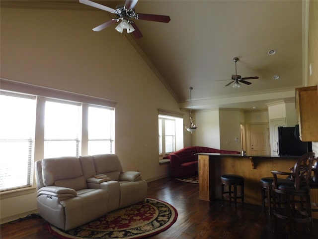 living room featuring dark hardwood / wood-style floors, ceiling fan, lofted ceiling, and crown molding