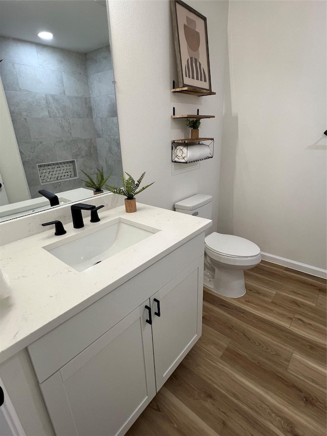 bathroom featuring hardwood / wood-style floors, vanity, and toilet