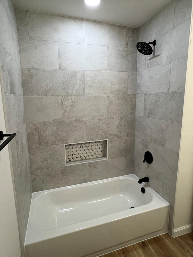 bathroom with tiled shower / bath combo and wood-type flooring