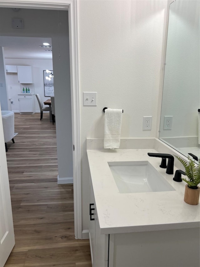 bathroom with vanity and hardwood / wood-style flooring