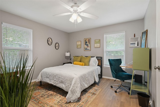 bedroom with ceiling fan and light hardwood / wood-style flooring