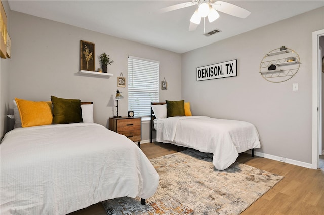 bedroom with ceiling fan and wood-type flooring