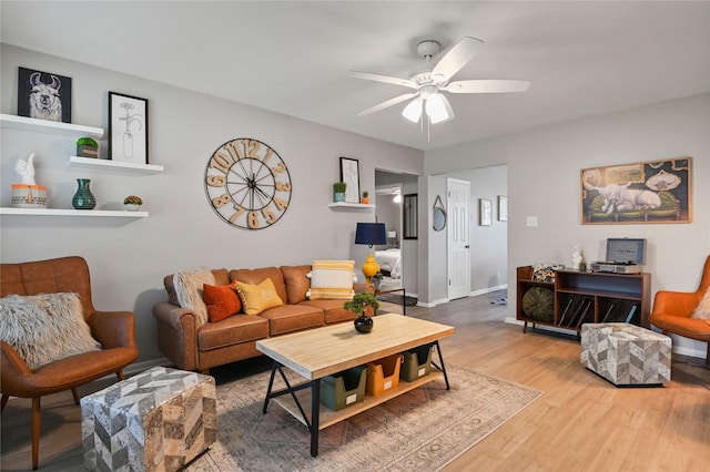 living room featuring hardwood / wood-style floors and ceiling fan