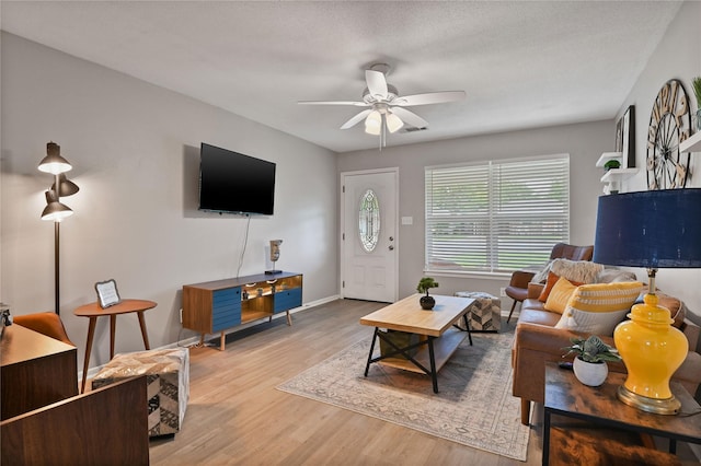 living room with ceiling fan and light hardwood / wood-style floors