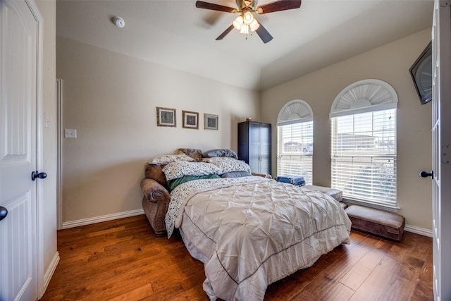 bedroom featuring ceiling fan, dark hardwood / wood-style floors, and vaulted ceiling