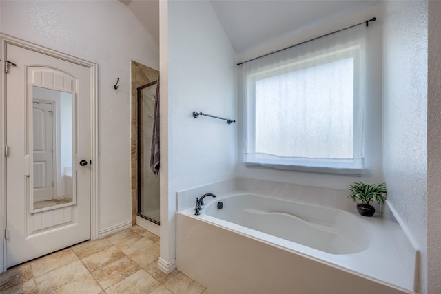 bathroom featuring independent shower and bath and vaulted ceiling