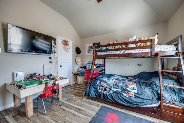 bedroom with lofted ceiling and wood-type flooring