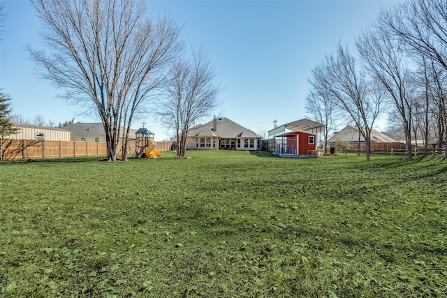 view of yard with a playground and a storage shed