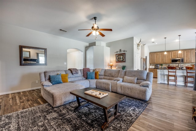 living room with hardwood / wood-style floors and ceiling fan