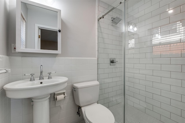 bathroom with toilet, tile walls, and an enclosed shower