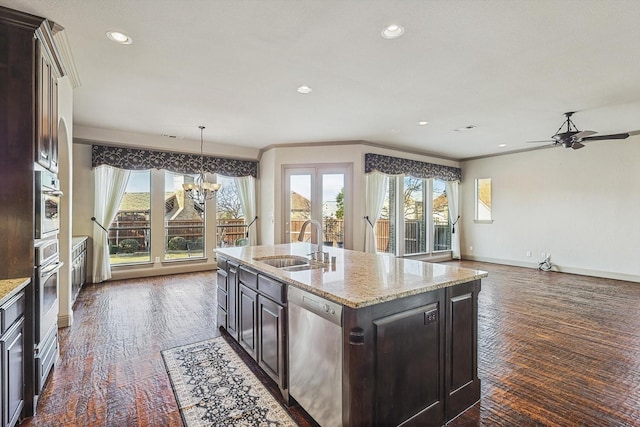 kitchen featuring sink, dark brown cabinets, an island with sink, and appliances with stainless steel finishes