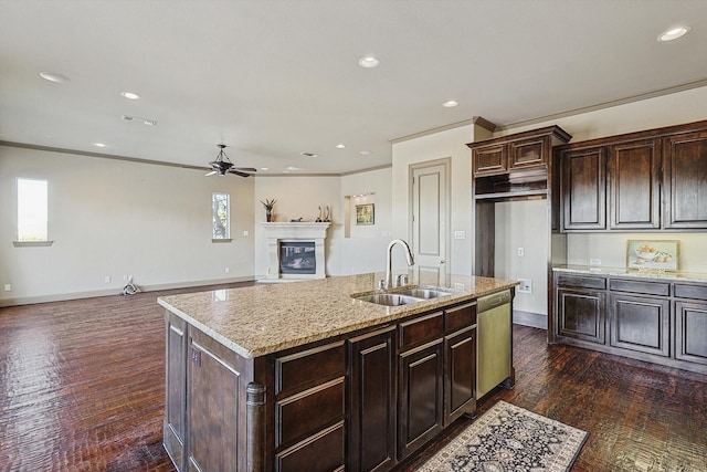 kitchen featuring sink, ornamental molding, dishwasher, and dark brown cabinetry