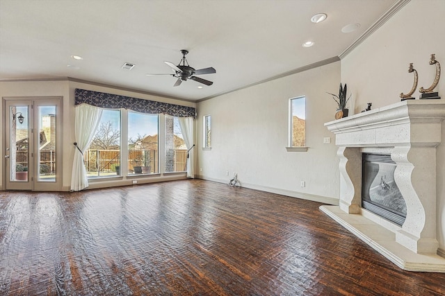 unfurnished living room with a high end fireplace, ceiling fan, ornamental molding, and hardwood / wood-style floors