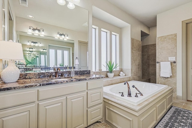 bathroom featuring vanity and a bath