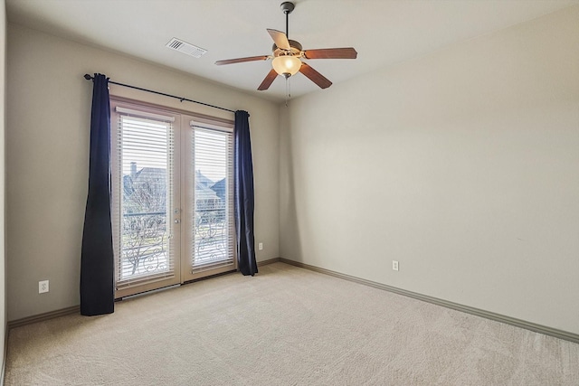 empty room with ceiling fan and light colored carpet