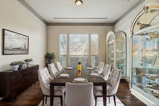 dining space with ornamental molding and dark hardwood / wood-style flooring