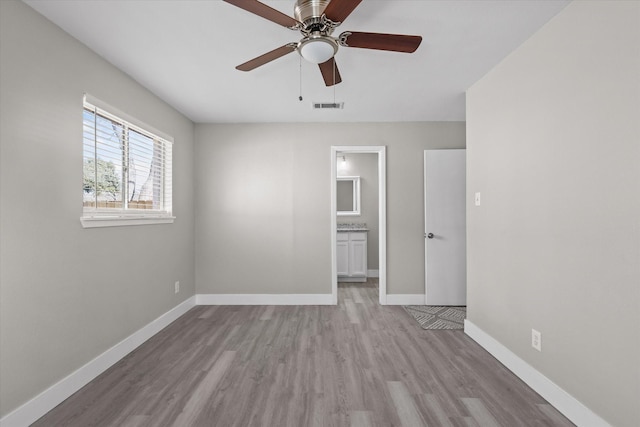 empty room featuring ceiling fan and light hardwood / wood-style floors