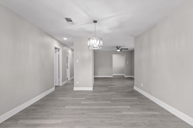 unfurnished dining area with ceiling fan and light hardwood / wood-style floors