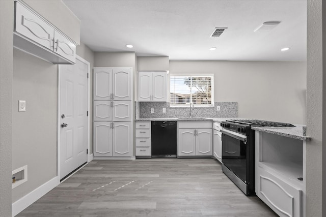 kitchen with sink, black dishwasher, gas range oven, backsplash, and white cabinets