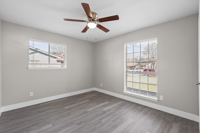 unfurnished room with ceiling fan and dark wood-type flooring