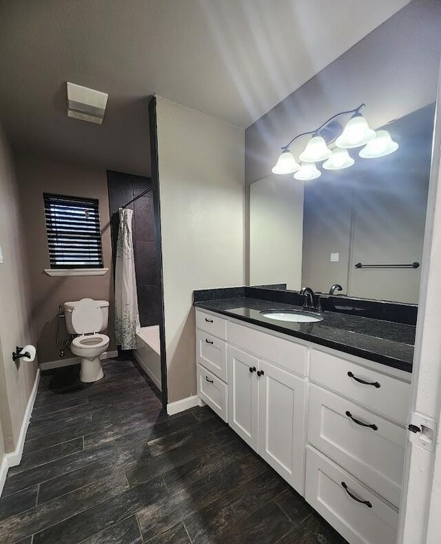 kitchen featuring white cabinetry, dark stone counters, and black appliances