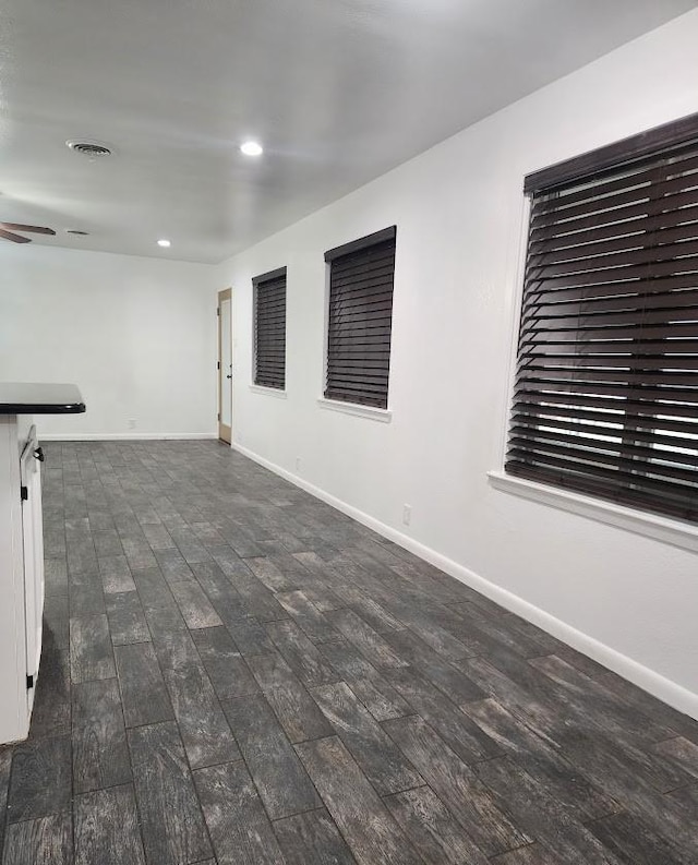 1911 College St, Gainesville, TX 76240 - spare room featuring dark wood-type flooring, recessed lighting, baseboards, and a ceiling fan