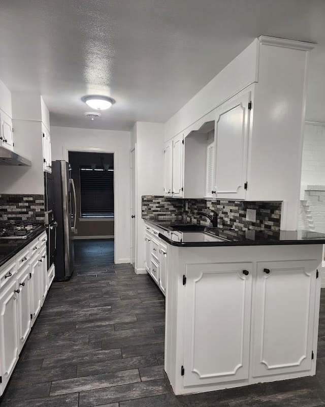 kitchen featuring white cabinetry, dark hardwood / wood-style floors, dishwasher, and decorative backsplash