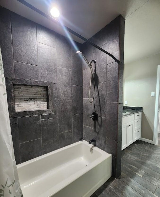 1911 College St, Gainesville, TX 76240 - bathroom with shower / bathtub combination with curtain, vanity, and wood finished floors