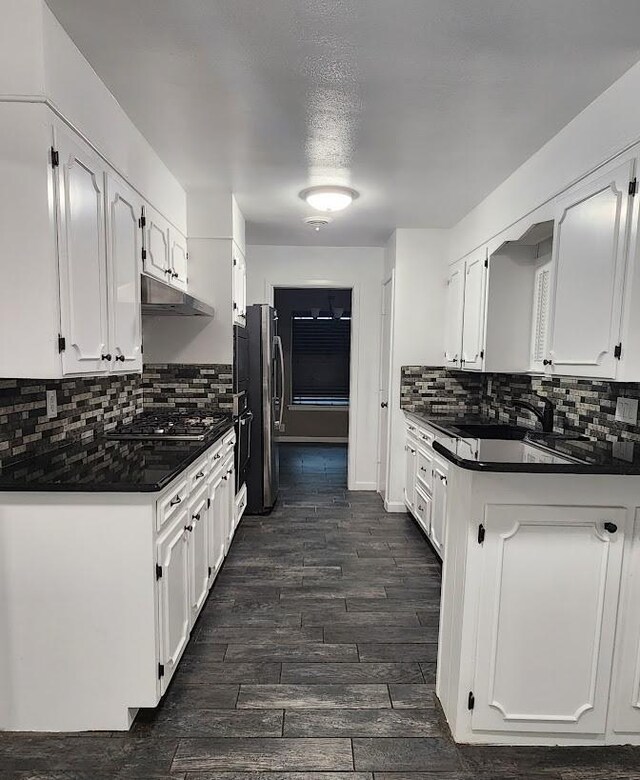 kitchen featuring appliances with stainless steel finishes, dark hardwood / wood-style floors, and white cabinets