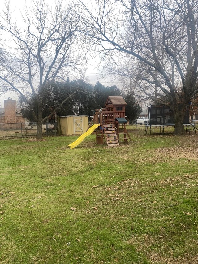 view of yard with a playground and a trampoline