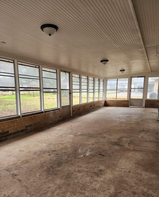 unfurnished sunroom with a wealth of natural light