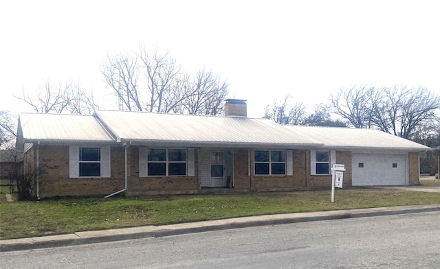 ranch-style house with a garage and a front yard