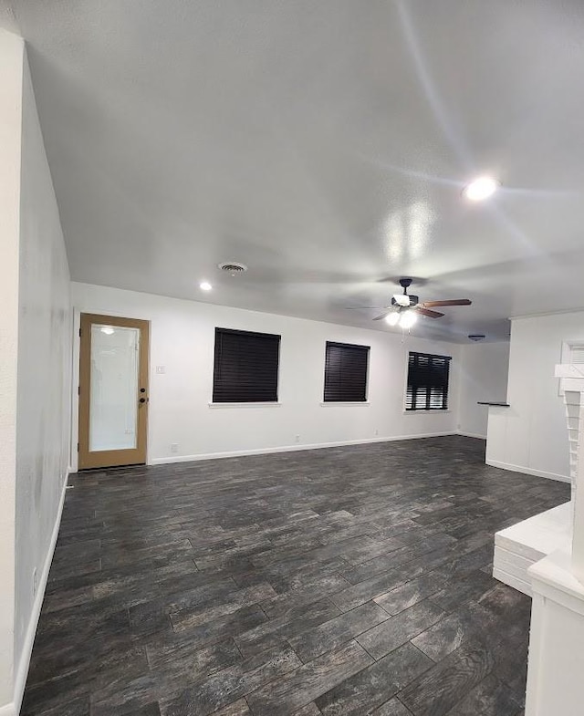 unfurnished room with dark hardwood / wood-style flooring and ceiling fan