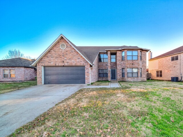 view of front of home with a garage and a front lawn