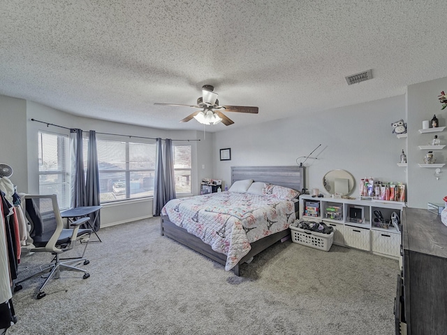 bedroom with a textured ceiling, ceiling fan, and carpet flooring