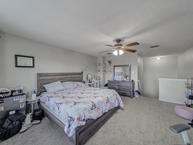 bedroom featuring a textured ceiling, ceiling fan, and carpet flooring