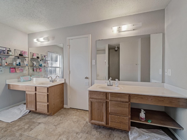 bathroom featuring a textured ceiling and vanity